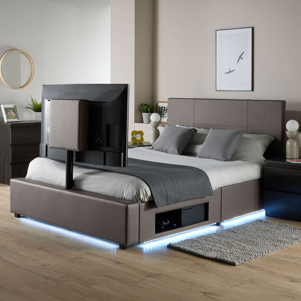 Modern bed with TV above in a bedroom setting