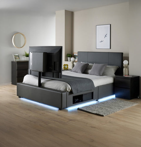 Modern bedroom with a black bed, nightstands, and decorative items.