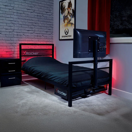 Bedroom with X-Rocker bed frame, gaming setup, and Overwatch poster.