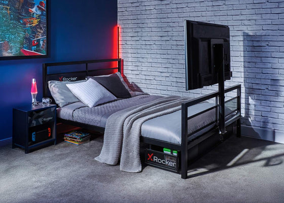 Modern bedroom with a bed, nightstands, and a TV against a brick wall.