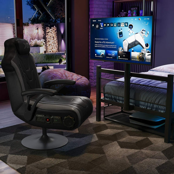 Gaming setup with a black recliner chair, gaming console, and TV displaying a game.