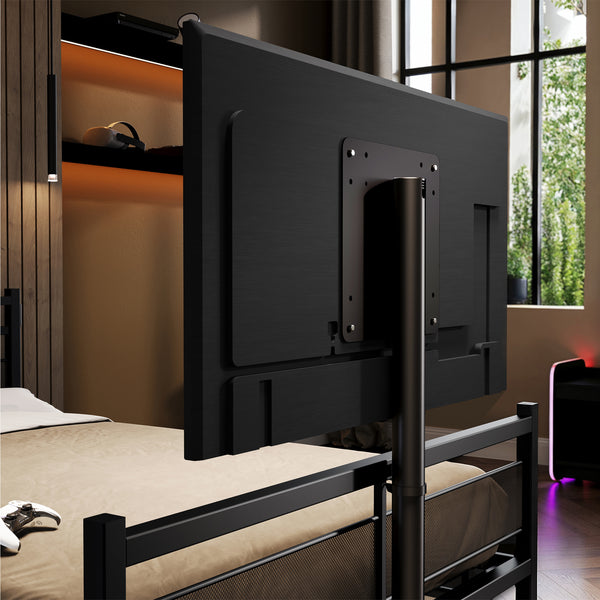 Black TV mount attached to a bed in a room with a window.