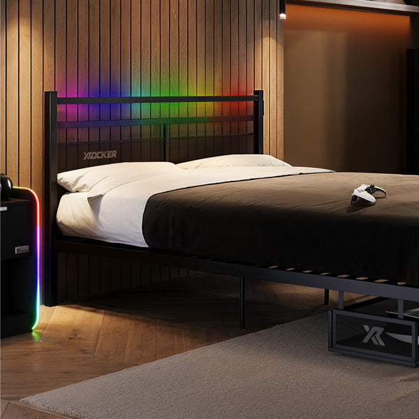 Bedroom with a bed featuring a colorful LED headboard and X rocker branding.