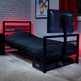 Bedroom with a basecamp tv gaming bed and TV setup, featuring X rocker branding.