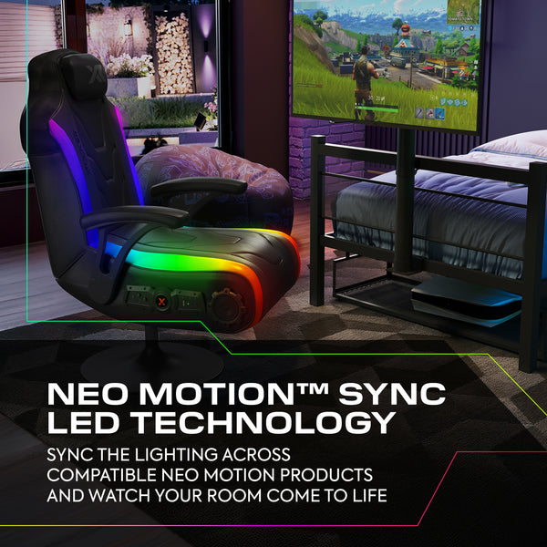 Gaming chair with Neo Motion Sync LED technology in a room setup with a TV and gaming console.