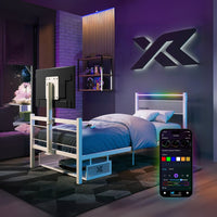 Modern bedroom with a bed and smart TV, featuring a smartphone app for control.