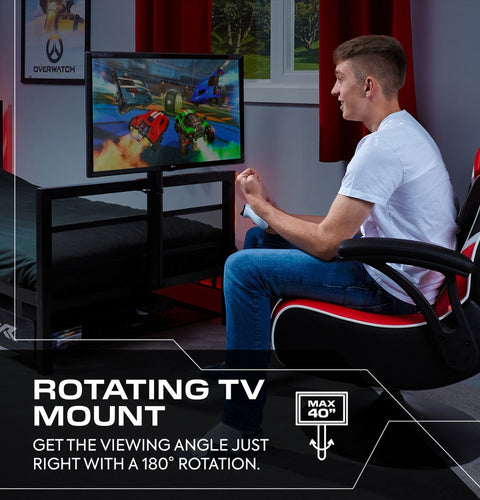 Person playing video games on a rotating TV mount in a gaming room.