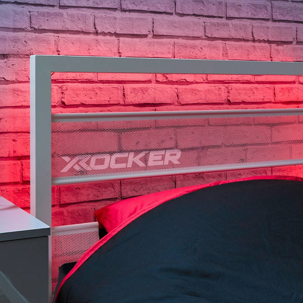 X rocker gaming chair with red lighting against a brick wall