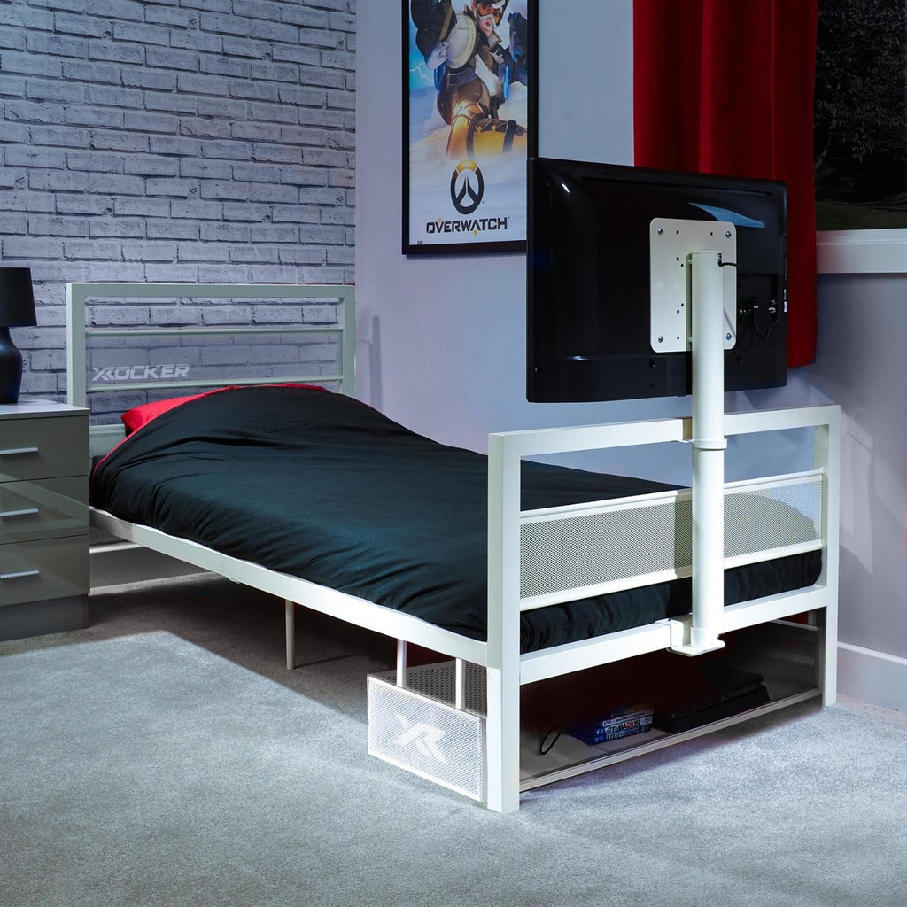 White tv bed with black mattress in a room with a TV and gaming posters.