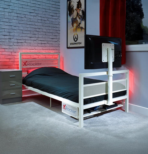 Bed with X rocker branding in a room setting with a TV and gaming decor.