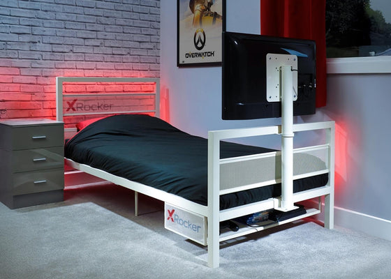 Bed with X rocker branding in a room setting with a TV and gaming decor.