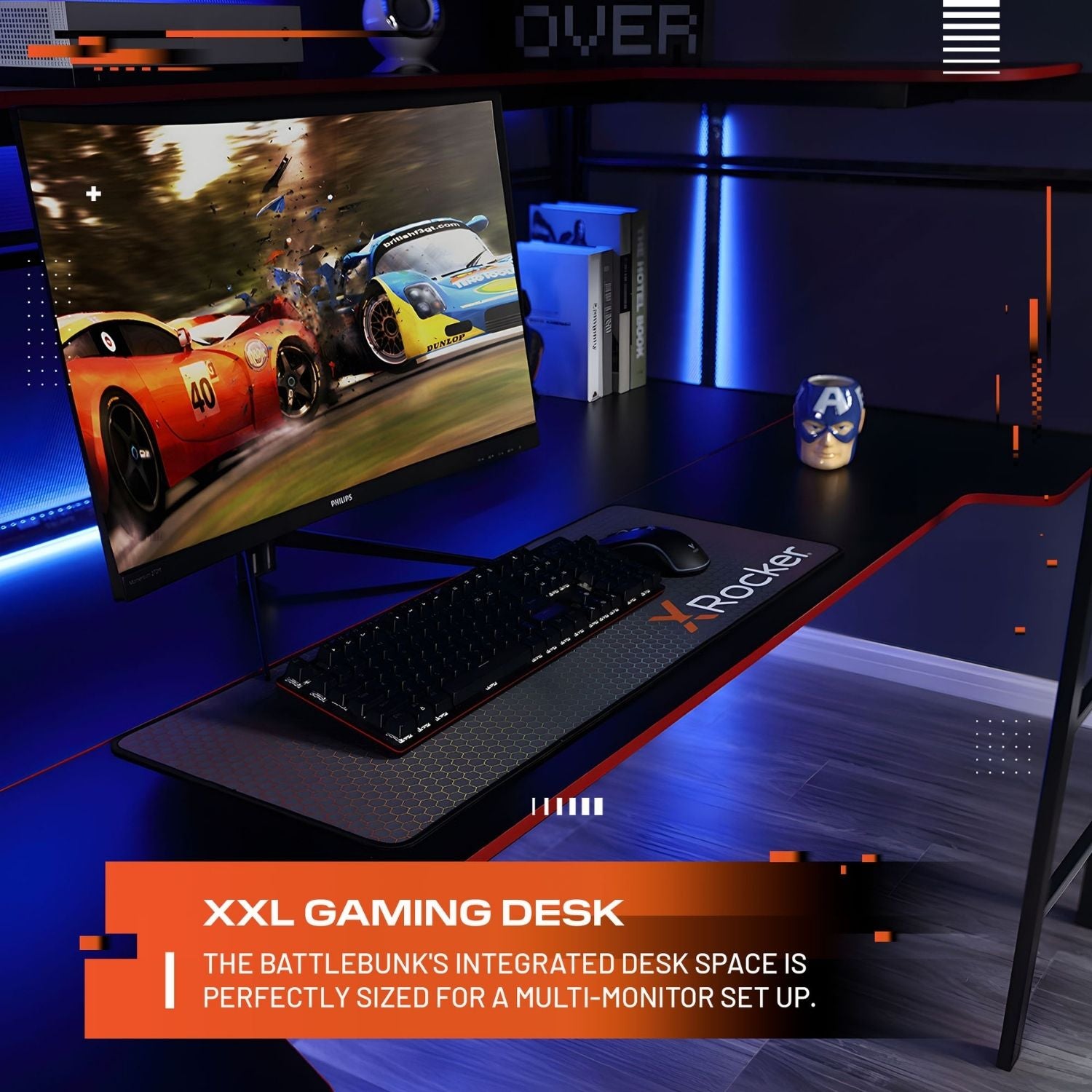 Gaming desk setup with monitor, keyboard, and mouse on a dark surface with blue lighting.