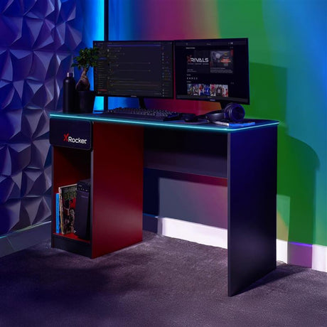 Gaming desk with dual monitors, keyboard, and mouse in a colorful room.