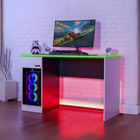 Gaming desk with RGB lighting, computer setup, and colorful monitor in a room with white brick walls.