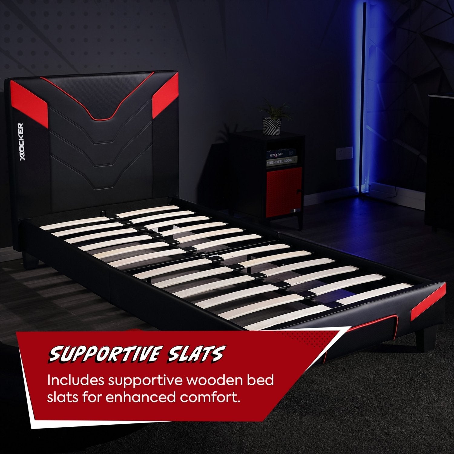 Black and red bed frame with supportive wooden slats in a dark room.
