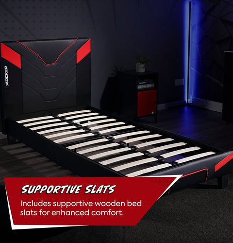 Black and red bed frame with supportive wooden slats in a dark room.