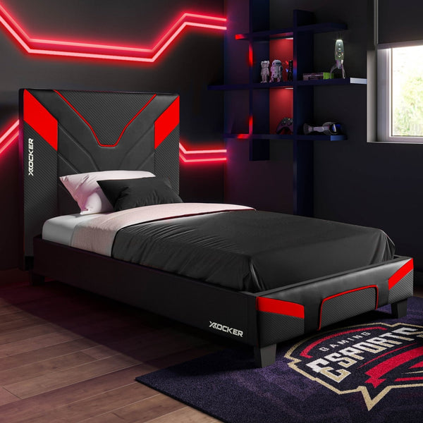 Gaming bedroom with X rocker bed, neon lights, and Esports-themed rug.