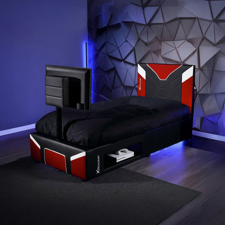 Modern bed with gaming console and screen in a room with geometric wall design