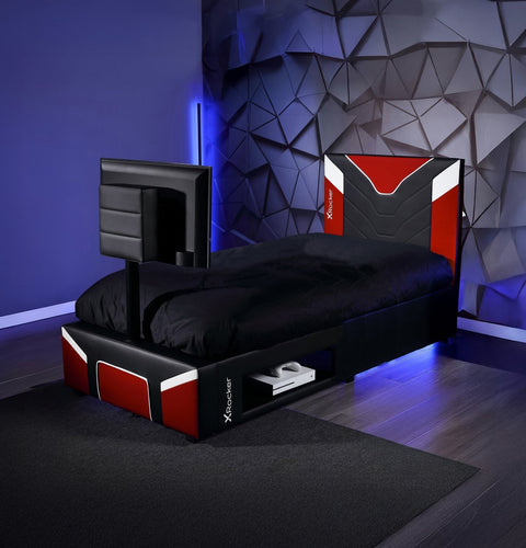 Modern bed with gaming console and screen in a room with geometric wall design