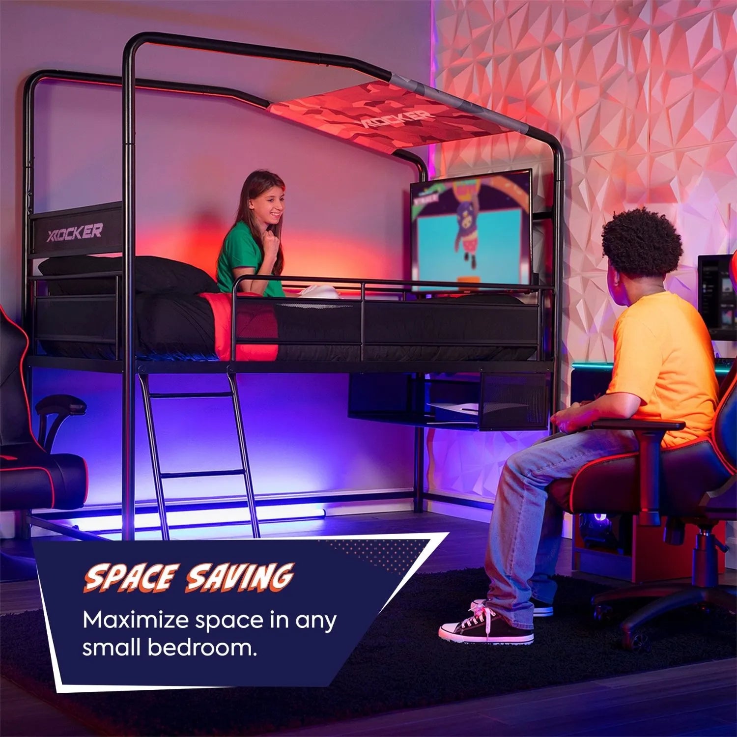 Two people using a space-saving desk setup in a bedroom with gaming equipment.