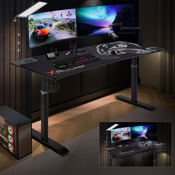 Gaming desk with multiple monitors and gaming accessories in a dimly lit room.