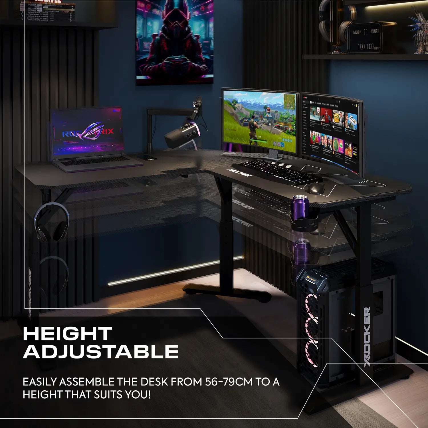 Gaming setup with height-adjustable desk, multiple monitors, and gaming equipment.
