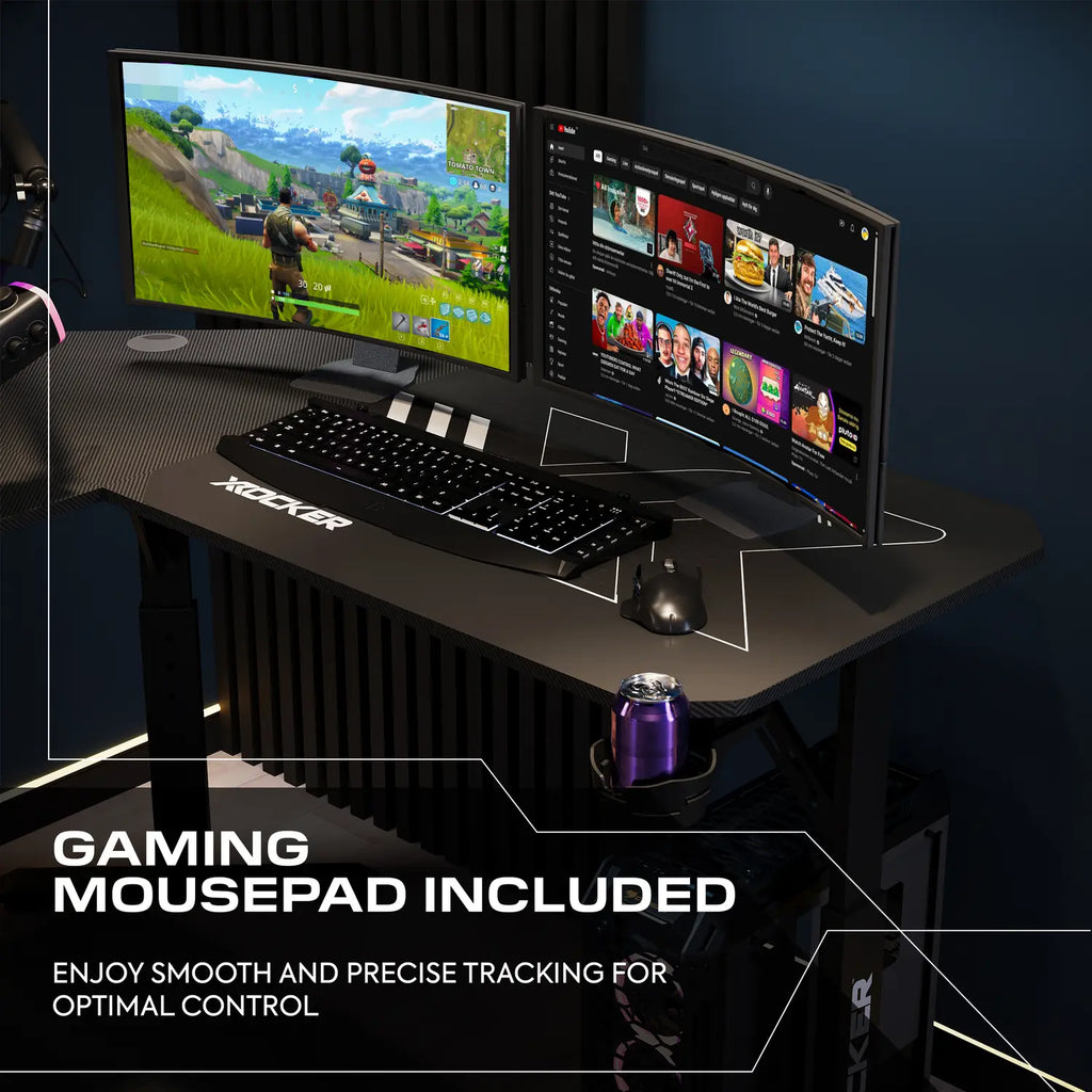 Gaming setup with dual monitors, keyboard, and mouse on a desk with a mousepad.