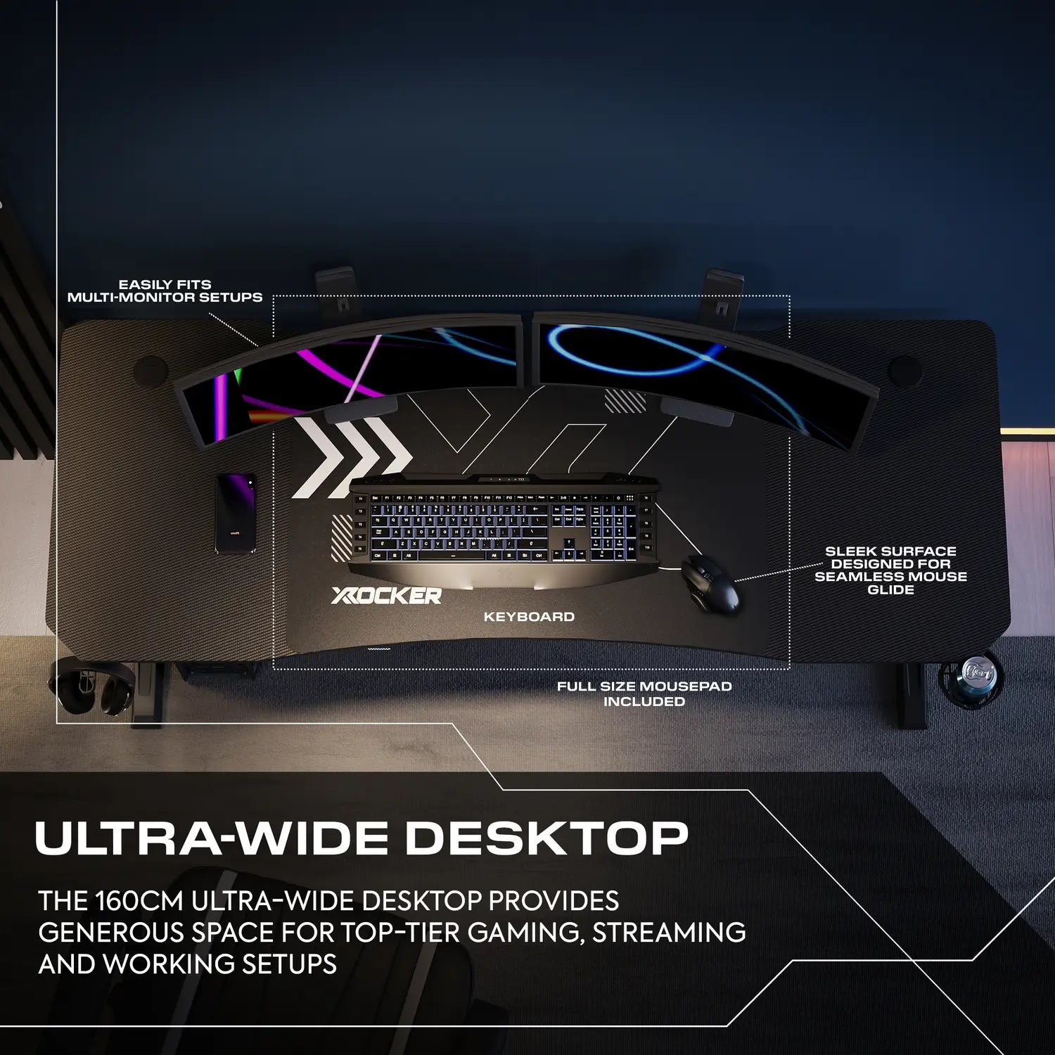 Gaming desk setup with keyboard, mousepad, and monitor stand on a dark background