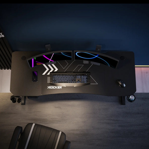 Cougar Gaming desk with mousepad and X rocker branding in a dark room.