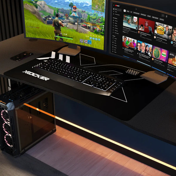 Gaming setup with a desk, keyboard, mouse, and computer monitors.