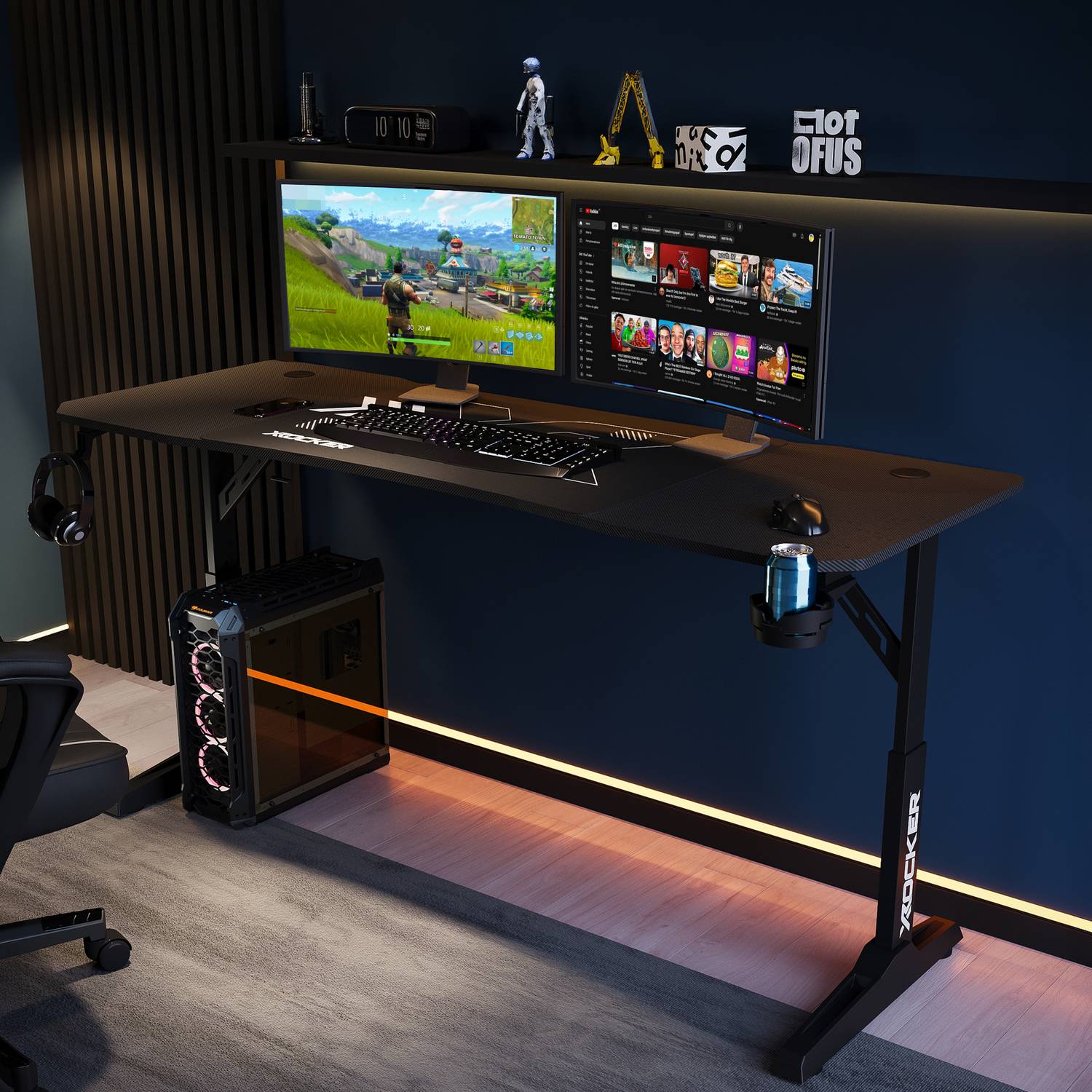 Gaming setup with a Cougar XL Height Adjustable desk, computer monitors, keyboard, and gaming chair in a dark room.