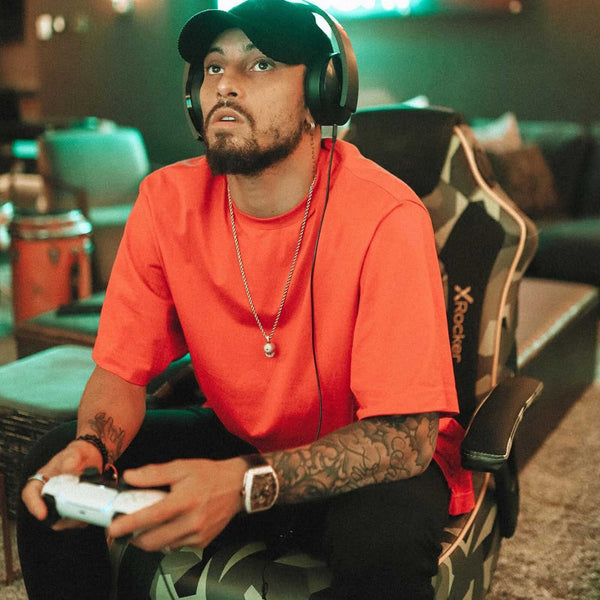 Man wearing headphones and playing a video game in a casual setting