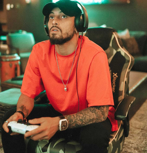 Man wearing headphones and playing a video game in a casual setting