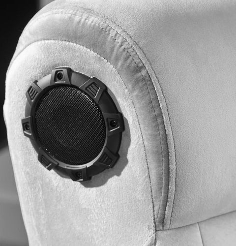 Black speaker grille on a gray car seat
