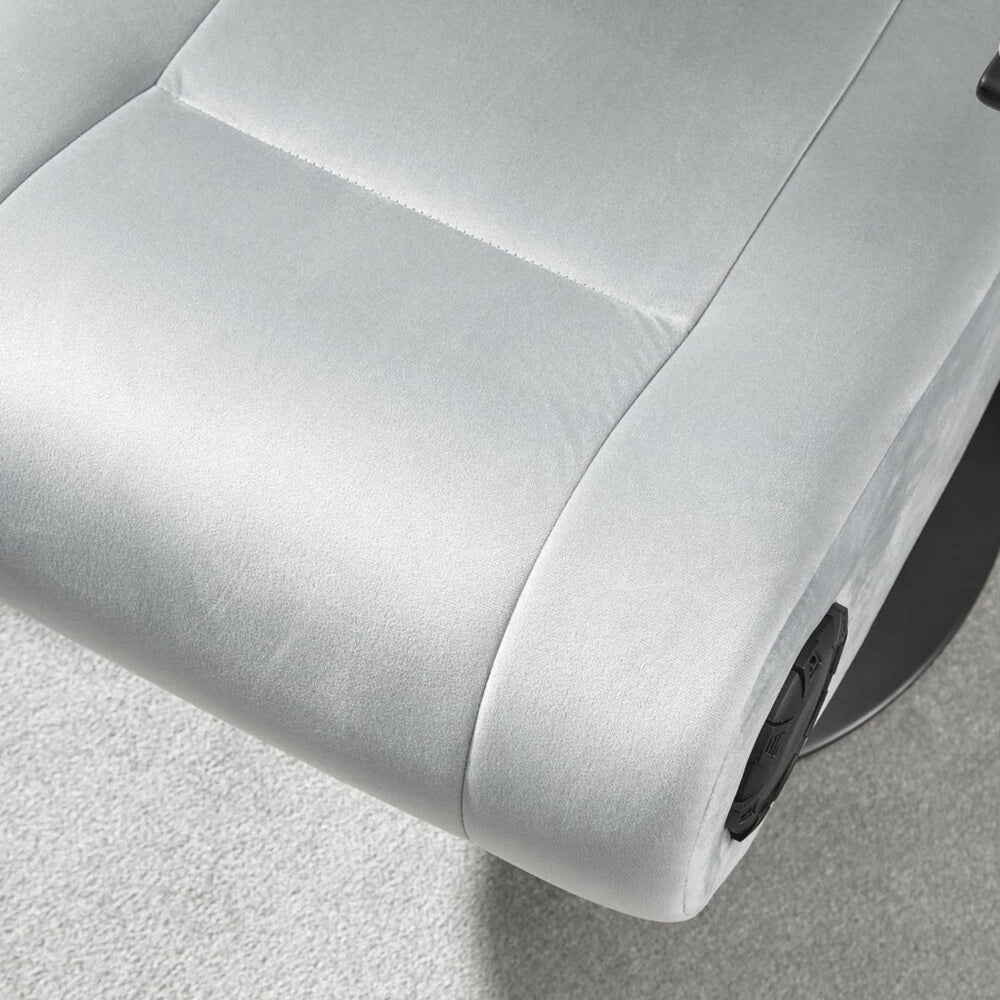 Close-up of a gray recliner chair with a focus on the armrest and seat.