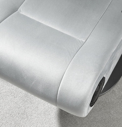 Close-up of a gray recliner chair with a focus on the armrest and seat.