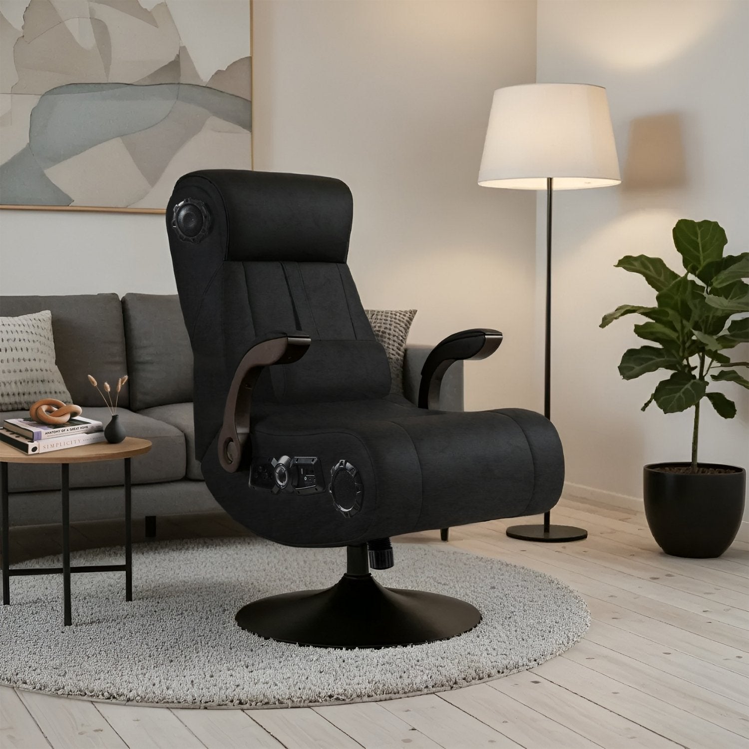 Black recliner chair in a living room setting with a lamp and plant.