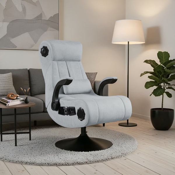 Gray gaming chair in a living room setting with a lamp and plant.