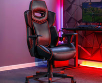 Gaming chair in a room with red lighting and a computer setup.