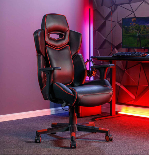 Gaming chair in a room with red lighting and a computer setup.