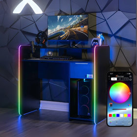 Gaming desk with RGB lighting, computer setup, and smartphone displaying lighting app.
