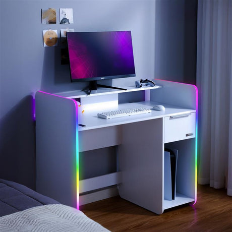 Modern white desk with computer setup in a room with RGB lighting