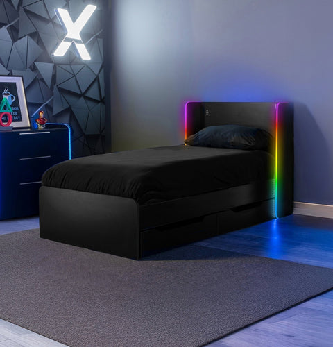 Black bed with RGB lighting and trundle drawers in a modern bedroom setting