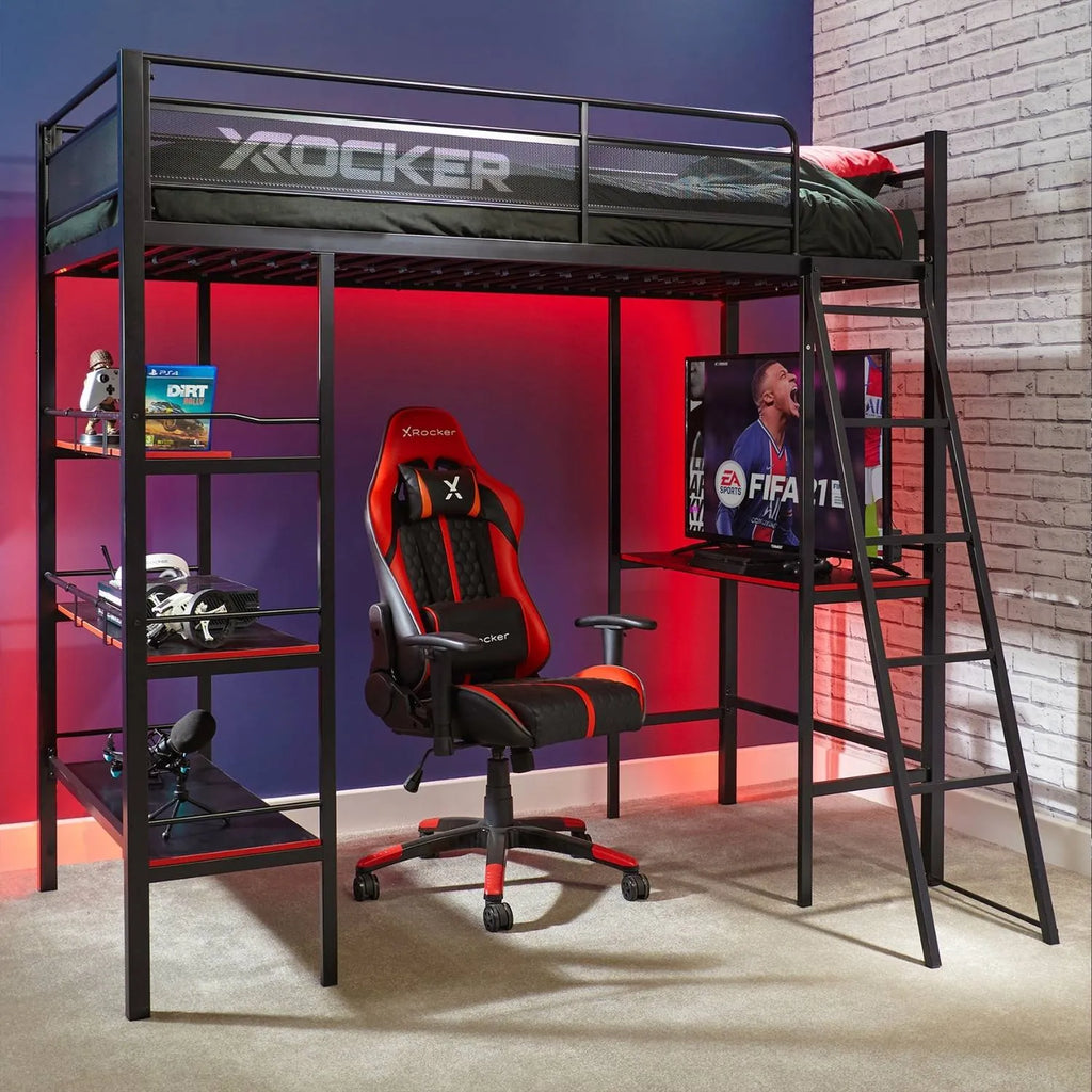 Gaming room setup with X rocker chair, desk, and computer setup.