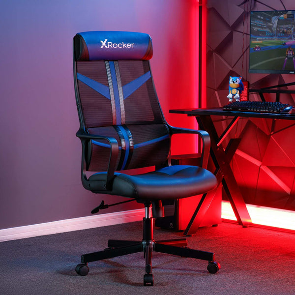 Gaming chair with X rocker logo in a room with red lighting and a computer setup.