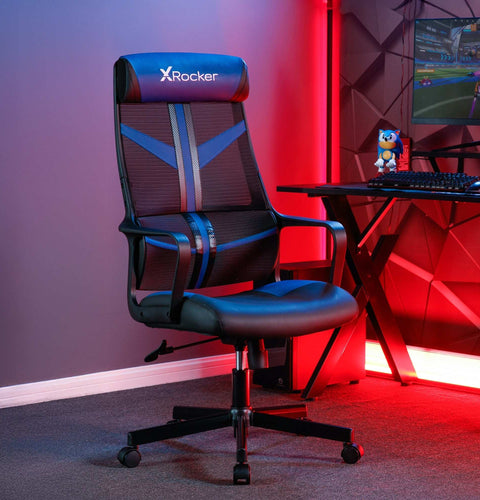 Gaming chair with X rocker logo in a room with red lighting and a computer setup.