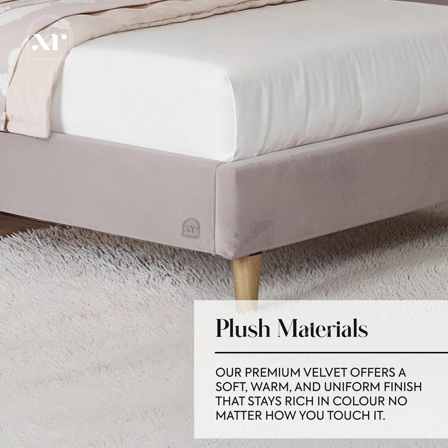 Gray bed frame with white mattress and pink blanket on a textured floor.