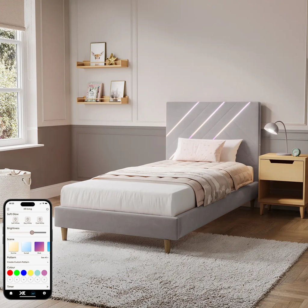Modern bedroom with a gray upholstered bed, nightstands, and shelves.