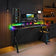 Gaming setup with RGB lighting on a desk in a room.