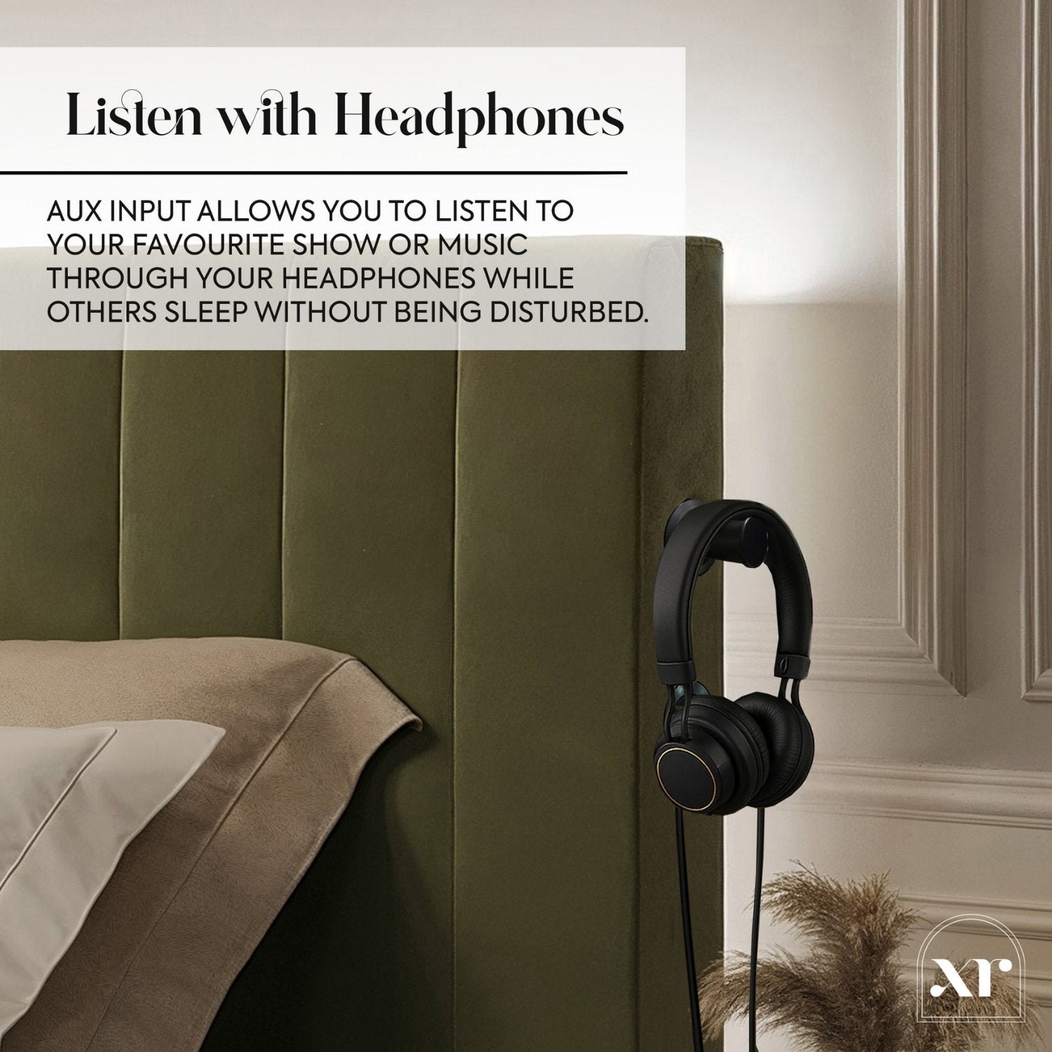 Headphones hanging on a green headboard with text about headphone use.